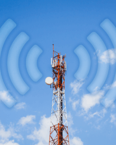 Telecommunications tower with antennas emitting wireless signal waves against a blue sky with clouds.
